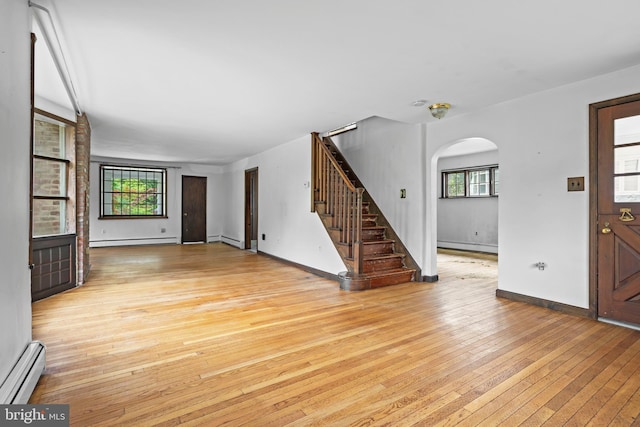 210 S Pennell Rd, Media, PA 19063 - foyer featuring a baseboard radiator, baseboard heating, arched walkways, light wood-style flooring, and plenty of natural light