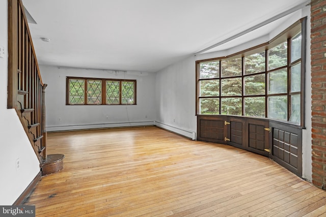 210 S Pennell Rd, Media, PA 19063 - unfurnished living room featuring light wood-style flooring, healthy amount of natural light, and stairs