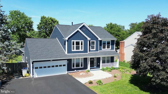 12910 Ashton Oaks Dr, Fairfax, VA 22030 - traditional-style house featuring a porch, a garage, board and batten siding, asphalt driveway, and a shingled roof