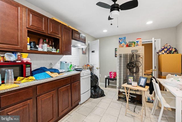 523 W Venango St, Philadelphia, PA 19140 - kitchen with under cabinet range hood, a ceiling fan, light countertops, decorative backsplash, and light tile patterned flooring