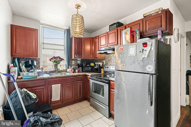 523 W Venango St, Philadelphia, PA 19140 - kitchen with appliances with stainless steel finishes, under cabinet range hood, tasteful backsplash, and decorative light fixtures