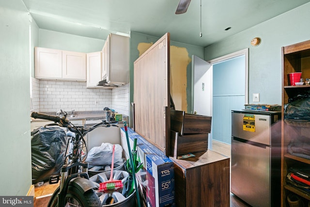 523 W Venango St, Philadelphia, PA 19140 - kitchen featuring freestanding refrigerator, decorative backsplash, and white cabinets