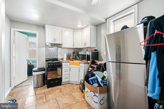 523 W Venango St, Philadelphia, PA 19140 - kitchen featuring stainless steel appliances, under cabinet range hood, white cabinets, tasteful backsplash, and light countertops