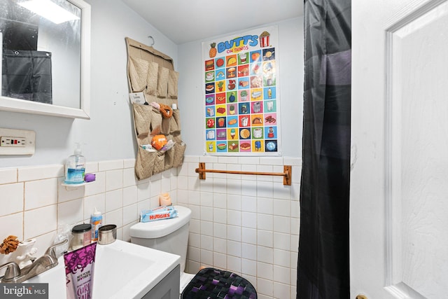 523 W Venango St, Philadelphia, PA 19140 - bathroom featuring a wainscoted wall, tile walls, and vanity