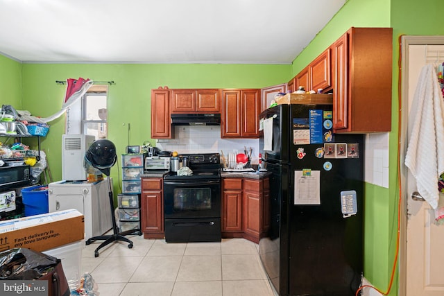 523 W Venango St, Philadelphia, PA 19140 - kitchen featuring black appliances, under cabinet range hood, decorative backsplash, light tile patterned flooring, and dark countertops