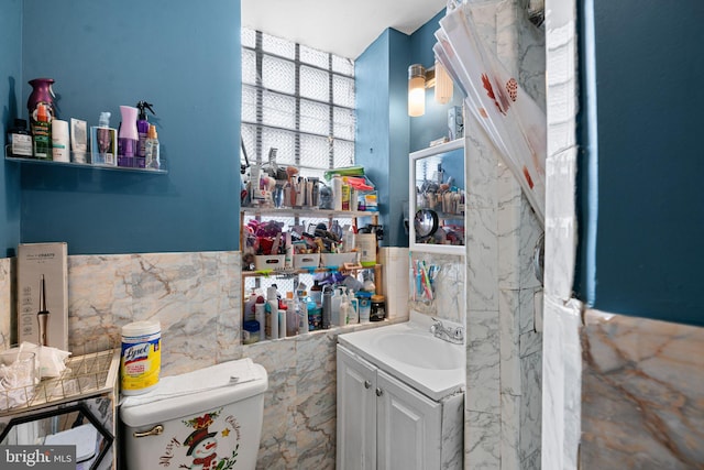 523 W Venango St, Philadelphia, PA 19140 - half bathroom with tile walls, vanity, and wainscoting