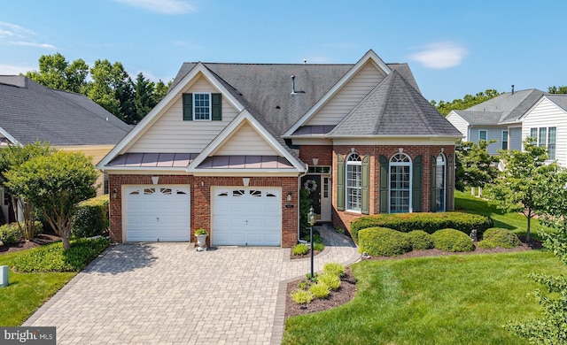 5230 Canyon Creek Way, Haymarket, VA 20169 - traditional-style house with brick siding, decorative driveway, a front yard, an attached garage, and a shingled roof