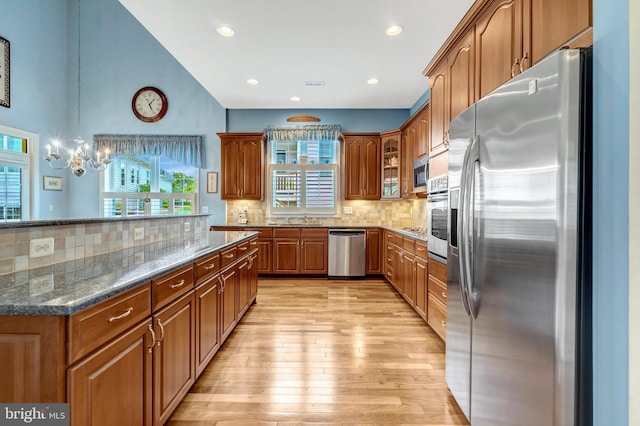 5230 Canyon Creek Way, Haymarket, VA 20169 - kitchen with stainless steel appliances, a chandelier, plenty of natural light, brown cabinets, and recessed lighting