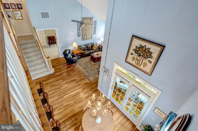 5230 Canyon Creek Way, Haymarket, VA 20169 - living area featuring high vaulted ceiling, stairway, wood finished floors, and a chandelier