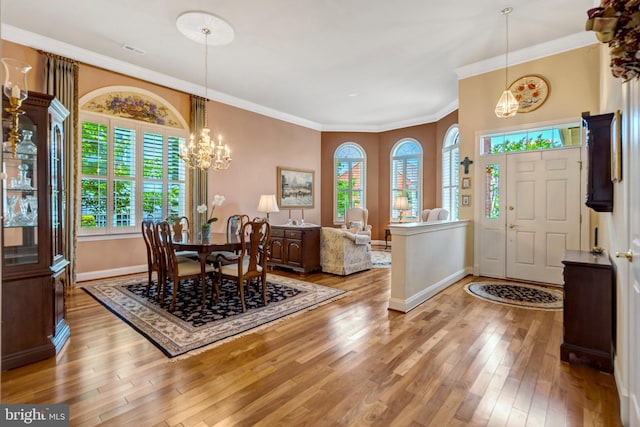 5230 Canyon Creek Way, Haymarket, VA 20169 - entryway featuring light wood finished floors, ornamental molding, and a chandelier