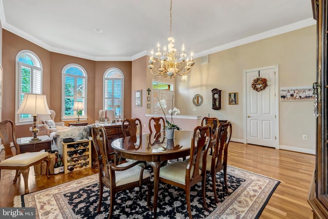 5230 Canyon Creek Way, Haymarket, VA 20169 - dining area with a chandelier, ornamental molding, and light wood-style flooring