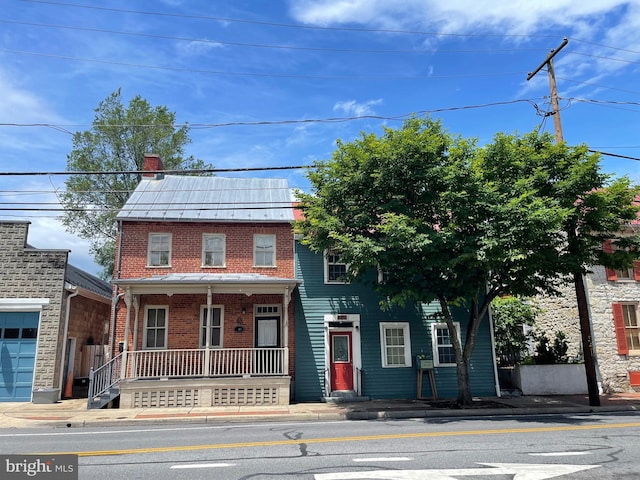209 S Braddock St, Winchester, VA 22601 - view of front of home with covered porch, brick siding, and a chimney