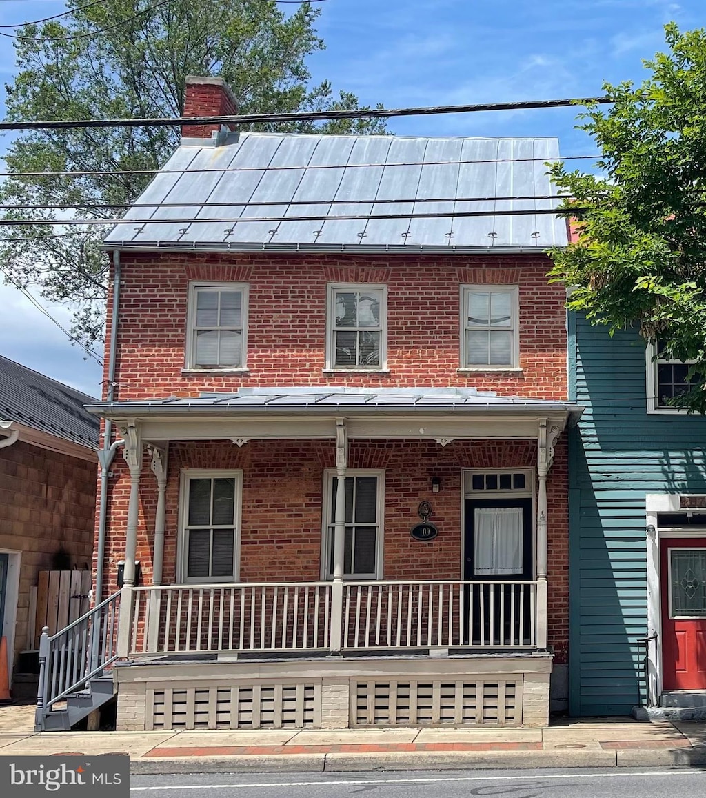 209 S Braddock St, Winchester, VA 22601 - townhome / multi-family property with covered porch, brick siding, and a chimney