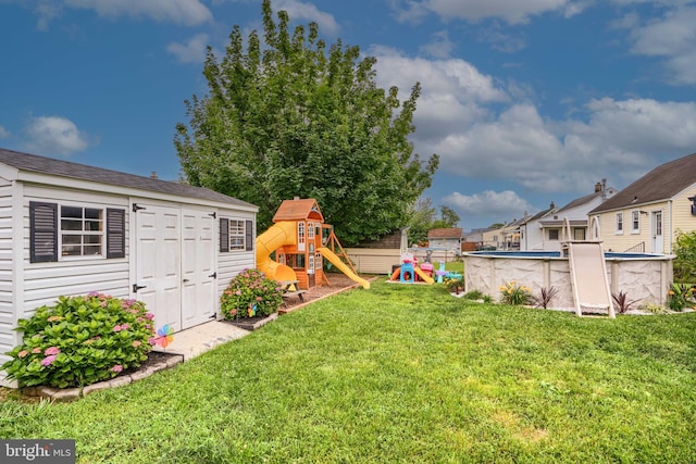 46 Avalon Ave, Dundalk, MD 21222 - view of grassy yard featuring a playground, a shed, and an outdoor pool