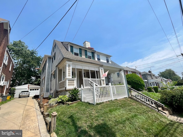 217 Bartlett Ave, Sharon Hill, PA 19079 - view of front of property with a porch, a front lawn, a chimney, and an outdoor structure