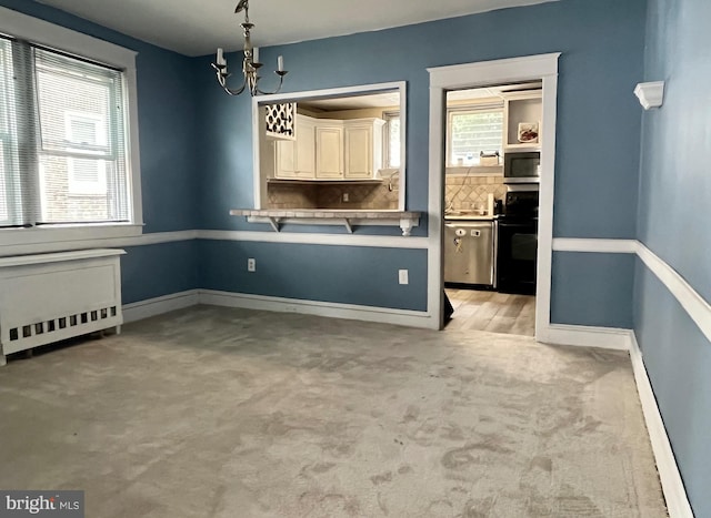 217 Bartlett Ave, Sharon Hill, PA 19079 - unfurnished dining area featuring radiator, a chandelier, and light carpet