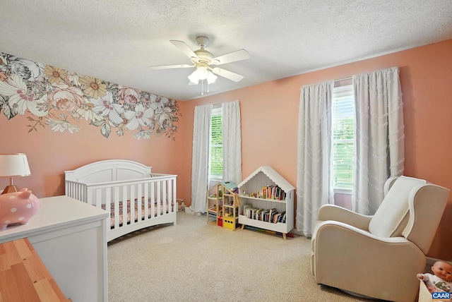 106 Alex Dr, Madison Heights, VA 24572 - bedroom featuring a nursery area, ceiling fan, a textured ceiling, and carpet floors