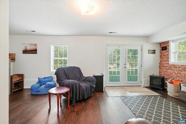 106 Alex Dr, Madison Heights, VA 24572 - living area featuring a wood stove, a textured ceiling, wood finished floors, and french doors
