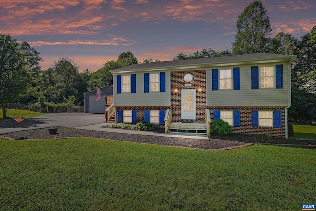 106 Alex Dr, Madison Heights, VA 24572 - split foyer home featuring brick siding, a front lawn, an outdoor structure, and a garage