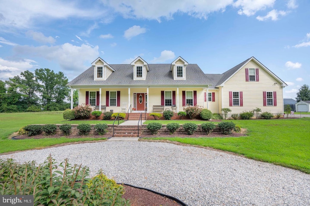1211 Dexter Corner Rd, Townsend, DE 19734 - cape cod house featuring covered porch, a front lawn, and a shingled roof