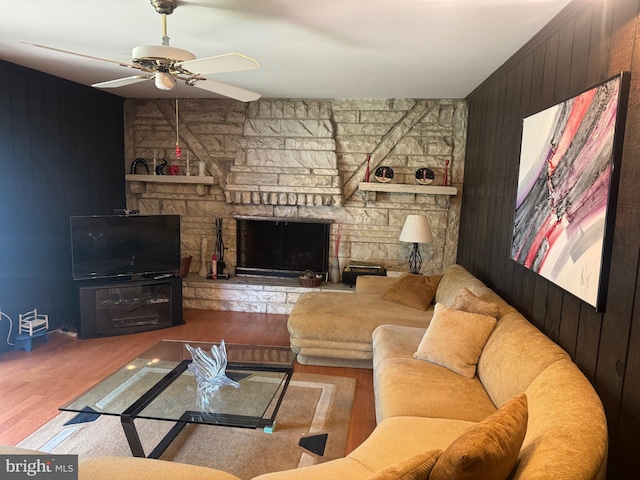 21 Stratton Dr, Hamilton, NJ 08690 - living room featuring wooden walls, a ceiling fan, wood finished floors, and a stone fireplace