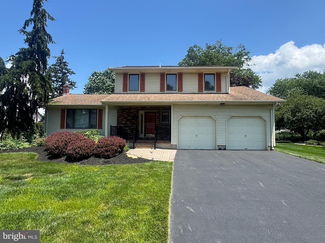 21 Stratton Dr, Hamilton, NJ 08690 - view of front of property with asphalt driveway, a chimney, a front yard, a porch, and a garage