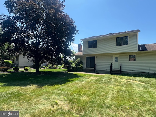 21 Stratton Dr, Hamilton, NJ 08690 - back of house with a lawn and entry steps