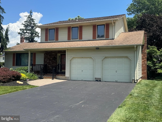 21 Stratton Dr, Hamilton, NJ 08690 - view of front of property featuring a garage, asphalt driveway, a porch, and a chimney