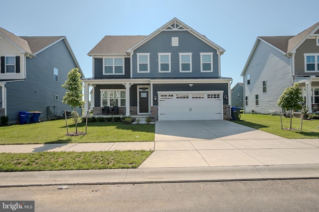 303 Jasper Way, Middletown, DE 19709 - craftsman-style house featuring stone siding, a porch, driveway, a front yard, and a garage
