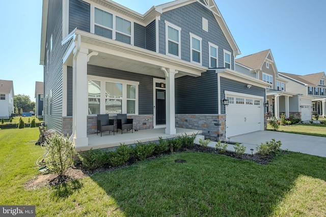 303 Jasper Way, Middletown, DE 19709 - craftsman-style home featuring covered porch, driveway, a front yard, stone siding, and a garage