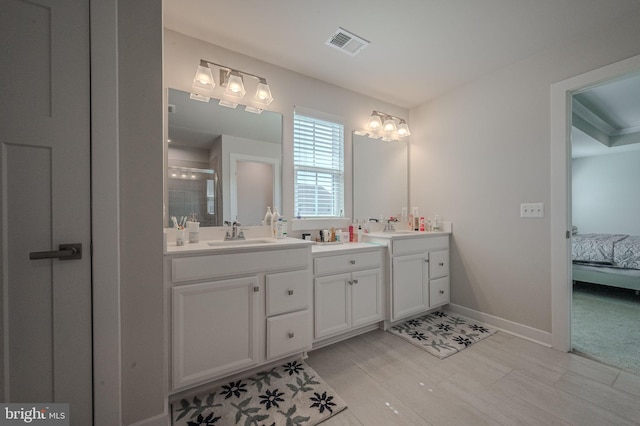 303 Jasper Way, Middletown, DE 19709 - ensuite bathroom featuring double vanity, wood finished floors, and a tile shower