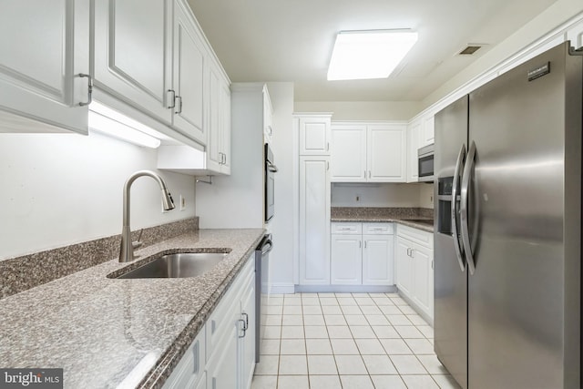 2019 Windrow Dr, Princeton, NJ 08540 - kitchen with stainless steel appliances, white cabinetry, light tile patterned flooring, and stone counters