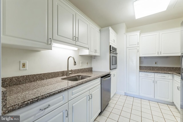 2019 Windrow Dr, Princeton, NJ 08540 - kitchen with stainless steel appliances, white cabinets, light tile patterned floors, and dark stone counters