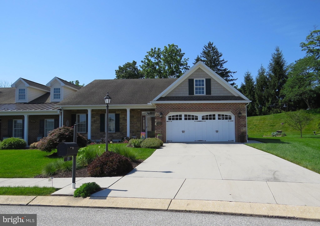 20 Digges Ct, Littlestown, PA 17340 - view of front of home featuring a front yard, concrete driveway, a garage, and brick siding