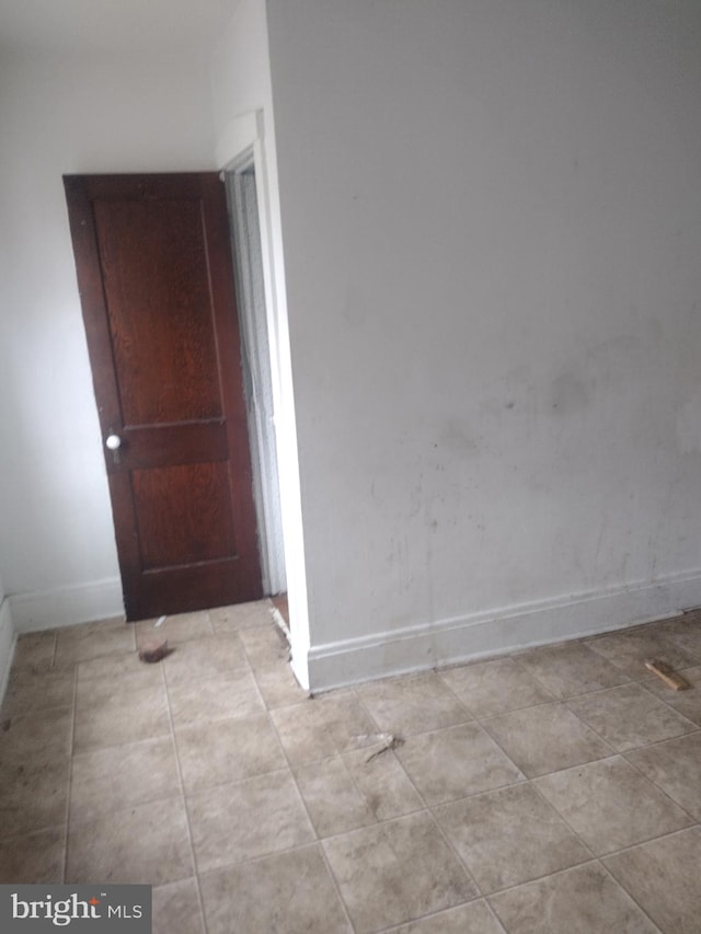 2714 E Biddle St, Baltimore, MD 21213 - unfurnished room featuring baseboards and light tile patterned floors