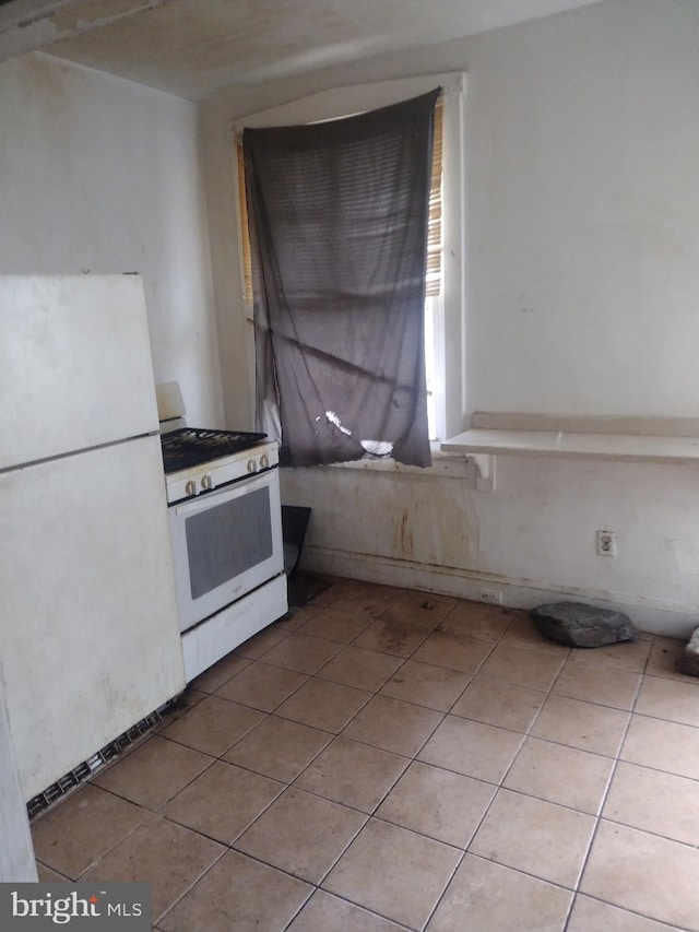 2714 E Biddle St, Baltimore, MD 21213 - kitchen with white appliances and tile patterned floors
