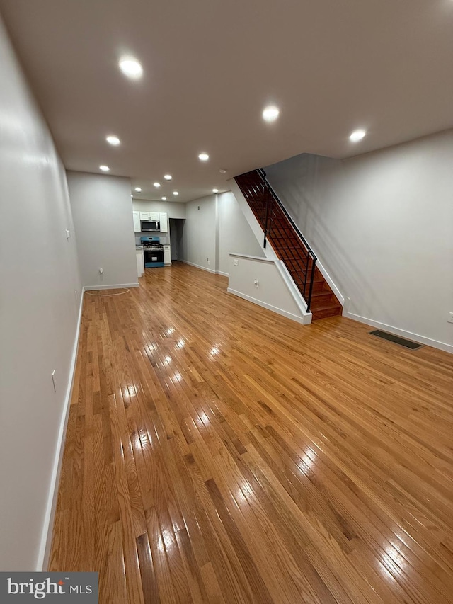 3844 N Franklin St, Philadelphia, PA 19140 - unfurnished living room featuring light wood-style floors, stairs, and recessed lighting