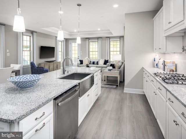 9976 Baker Ln, Ellicott City, MD 21042 - kitchen featuring stainless steel appliances, a tray ceiling, open floor plan, light wood-style flooring, and recessed lighting