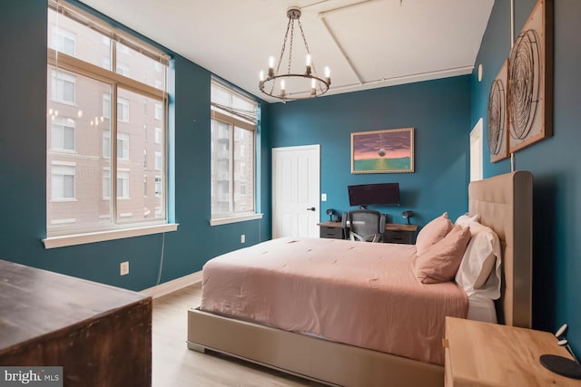 4480 Market Commons Dr Unit 215, Fairfax, VA 22033 - bedroom featuring a chandelier and wood finished floors