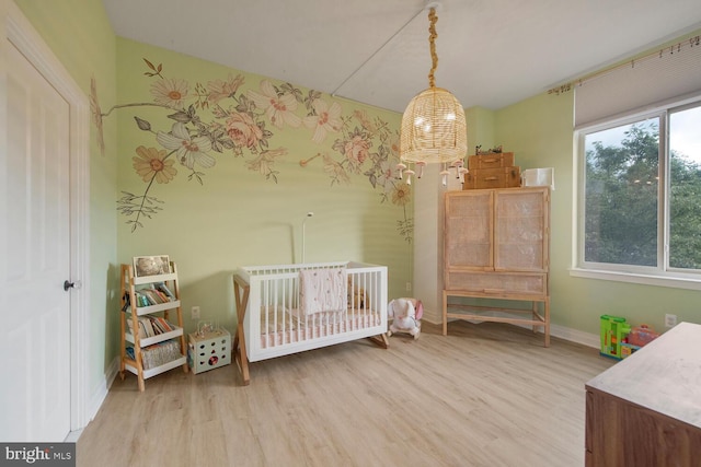 4480 Market Commons Dr Unit 215, Fairfax, VA 22033 - bedroom featuring wood finished floors and a crib