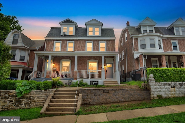 136 W 3rd Ave, Conshohocken, PA 19428 - view of property with brick siding, covered porch, and stairway