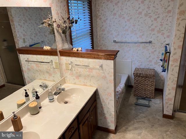 409 Rhoda Dr, Lancaster, PA 17601 - bathroom with double vanity, wallpapered walls, a bath, and a stall shower