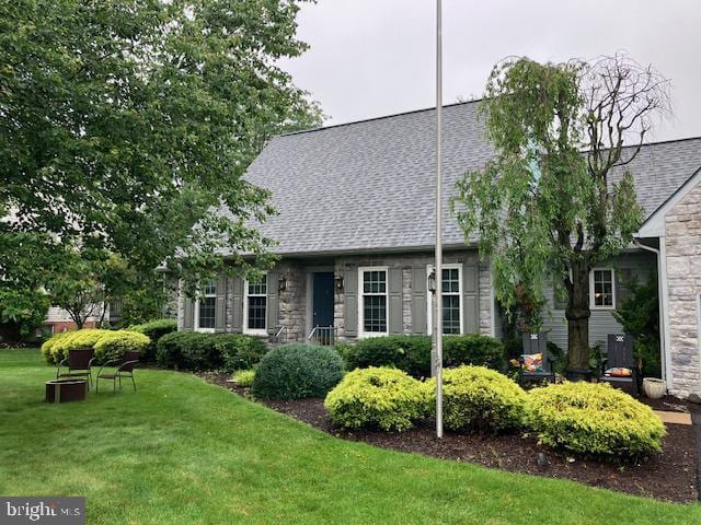 409 Rhoda Dr, Lancaster, PA 17601 - view of front of house featuring stone siding, a front lawn, and a shingled roof