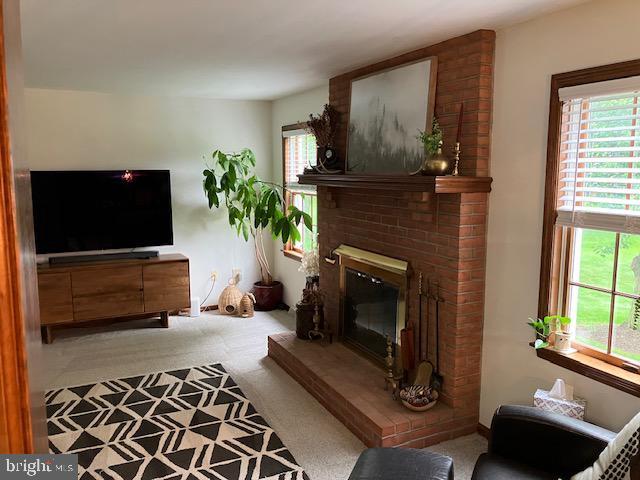 409 Rhoda Dr, Lancaster, PA 17601 - living area with carpet floors and a brick fireplace