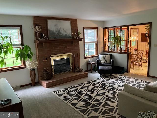 409 Rhoda Dr, Lancaster, PA 17601 - carpeted living room featuring a brick fireplace and baseboards