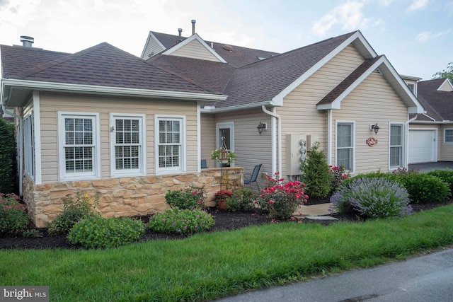3301 Shellers Bnd Unit 909, State College, PA 16801 - view of front of house with a shingled roof, stone siding, and a garage