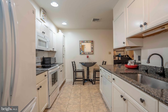3301 Shellers Bnd Unit 909, State College, PA 16801 - kitchen featuring white appliances, dark stone counters, white cabinetry, recessed lighting, and light tile patterned floors