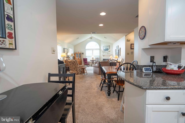 3301 Shellers Bnd Unit 909, State College, PA 16801 - kitchen with light carpet, white cabinets, lofted ceiling, open floor plan, and recessed lighting