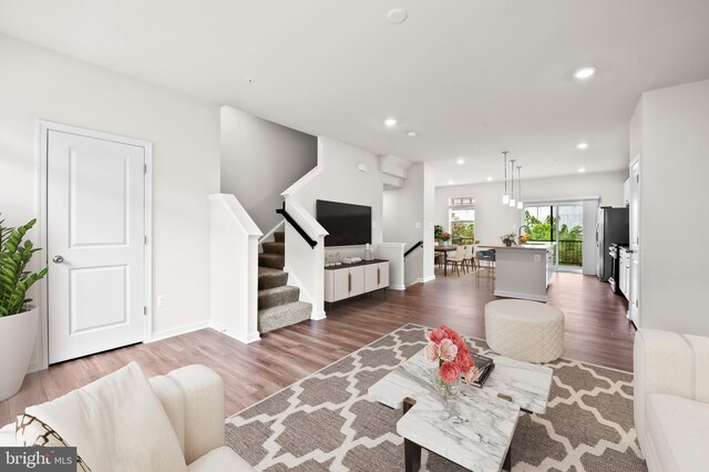 620 Mozart Way, Baltimore, MD 21224 - living room featuring dark wood-style floors, recessed lighting, and stairway