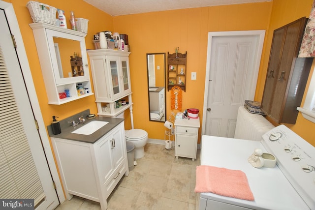 4425 E Howell St, Philadelphia, PA 19135 - bathroom with washer / dryer, radiator, vanity, and tile patterned floors